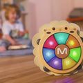 Little-girl-playing-with-her-musical-drum-toy-in-her-room